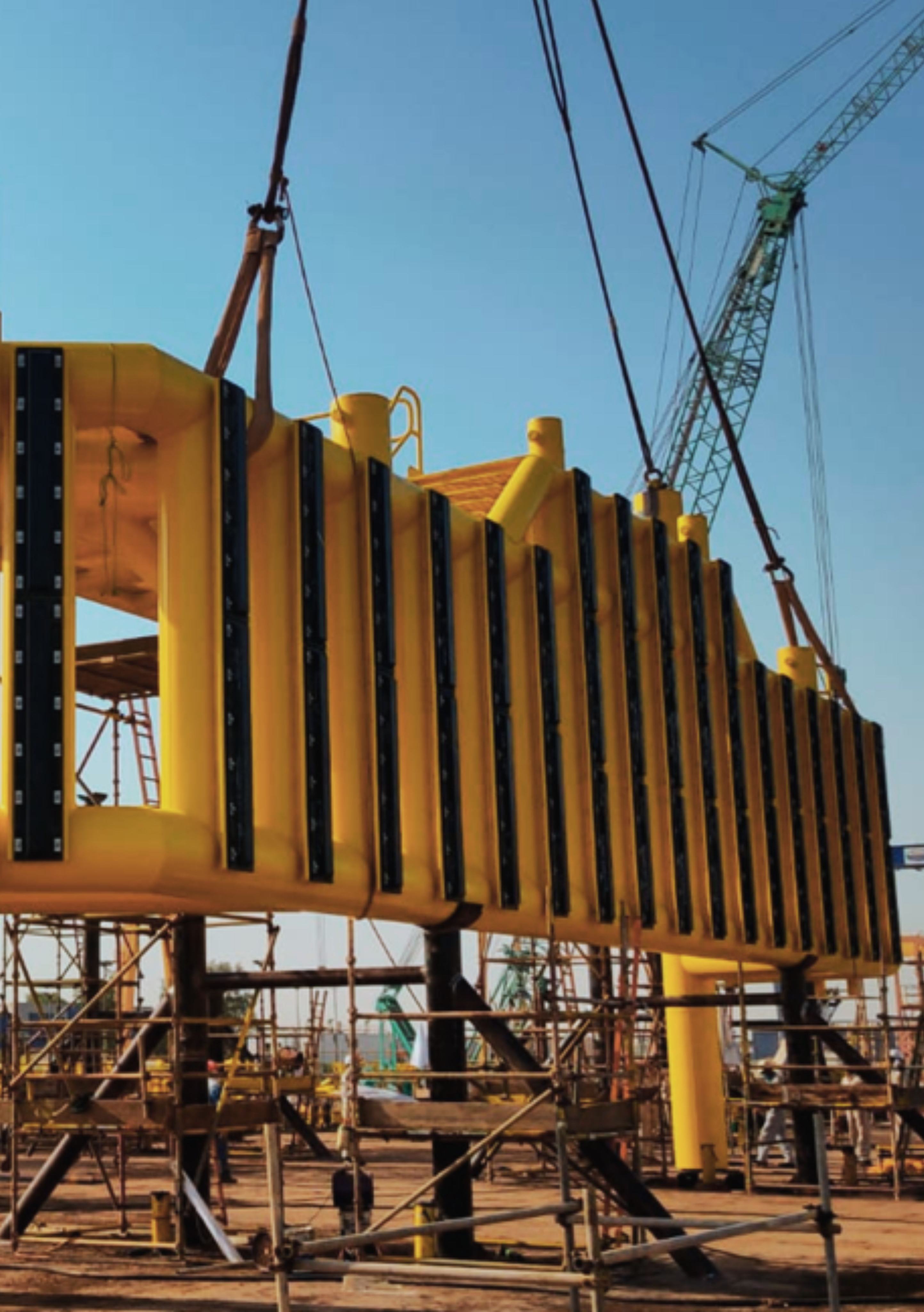 Bridge and boat landing structure being lifted by cranes